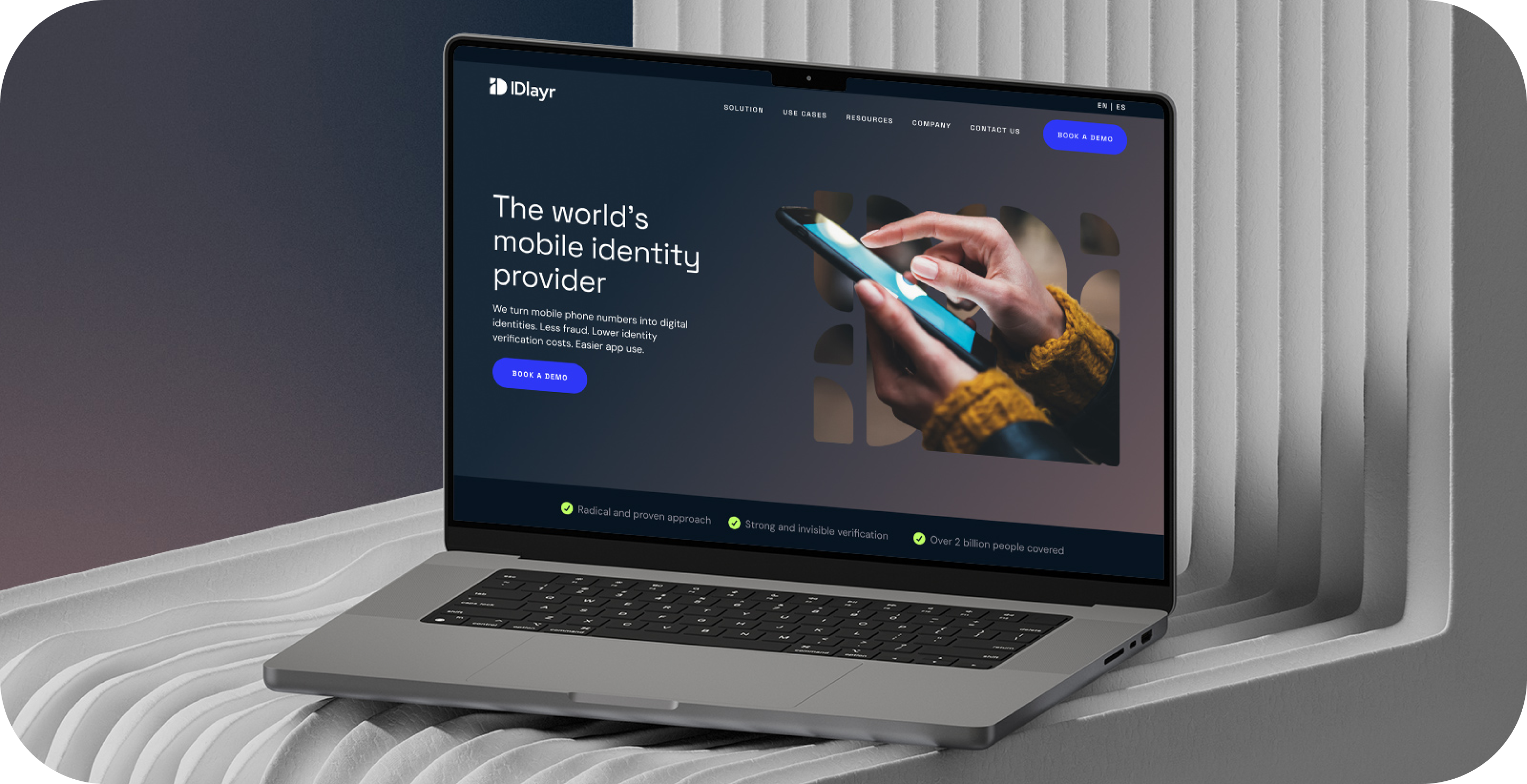 B2B branding. Laptop displaying ID Layr website. "The world's mobile identity provider" "BOOK A DEMO"